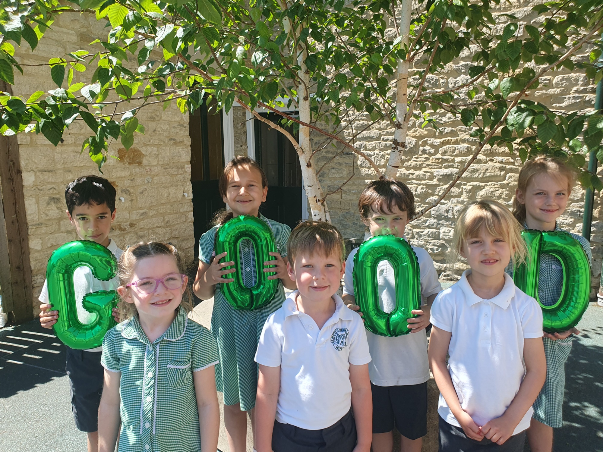 Children hold balloons at St Marys CE Infant School Witney